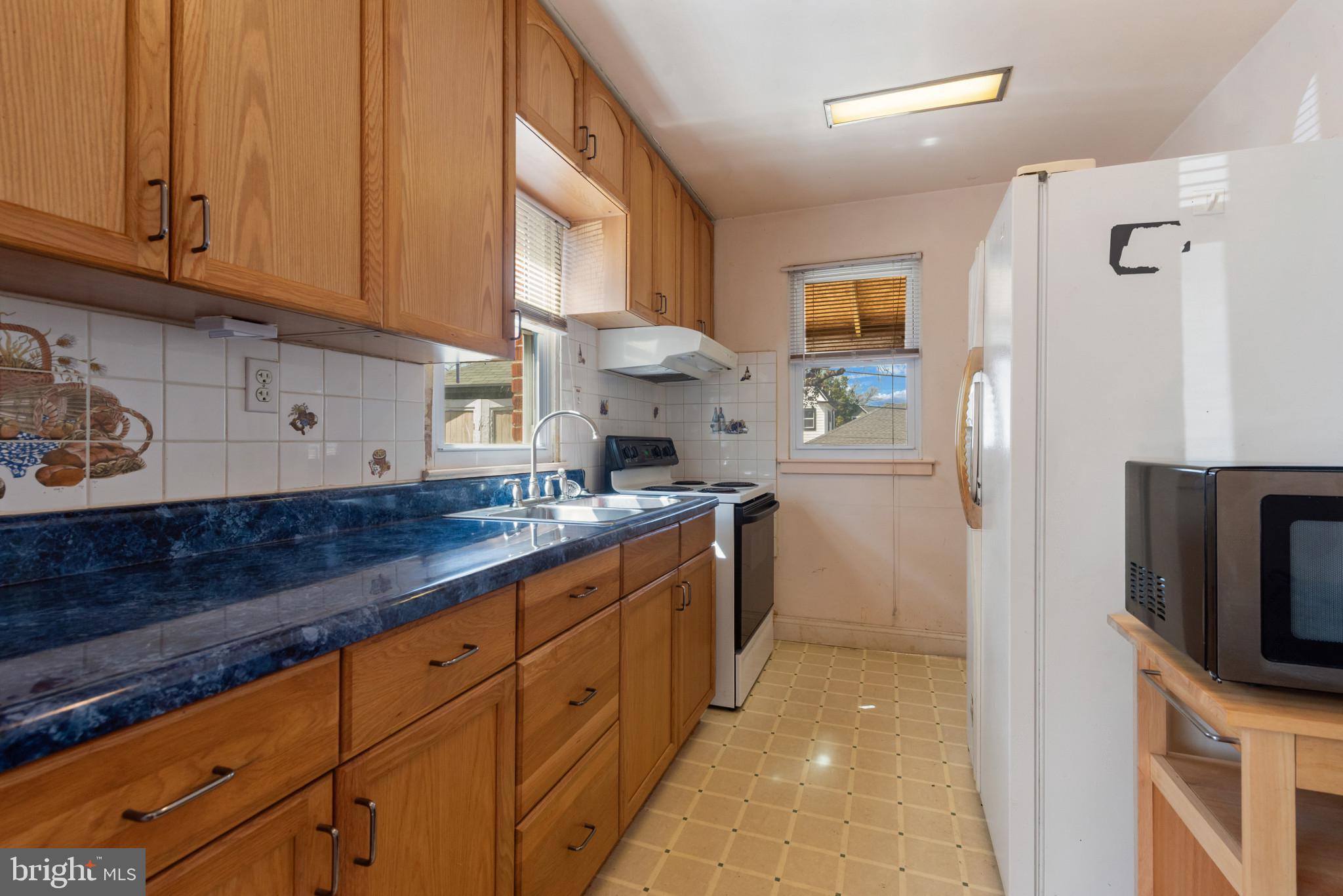 5016 Morello Road Baltimore, MD 21214 - Photo 9 of 16 a kitchen with cabinets a sink and appliances