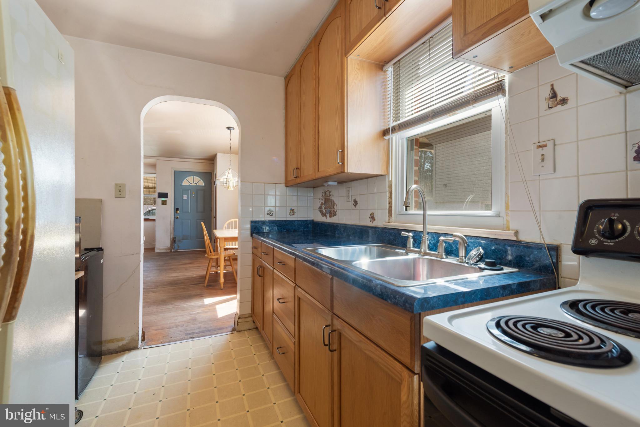5016 Morello Road Baltimore, MD 21214 - Photo 10 of 16 a kitchen with sink a stove and refrigerator