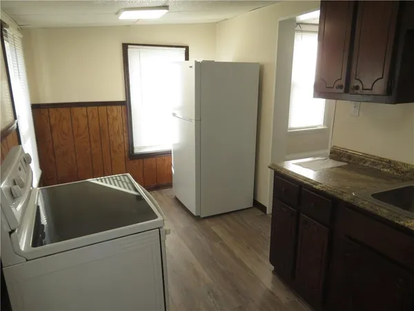a kitchen with a refrigerator and a sink