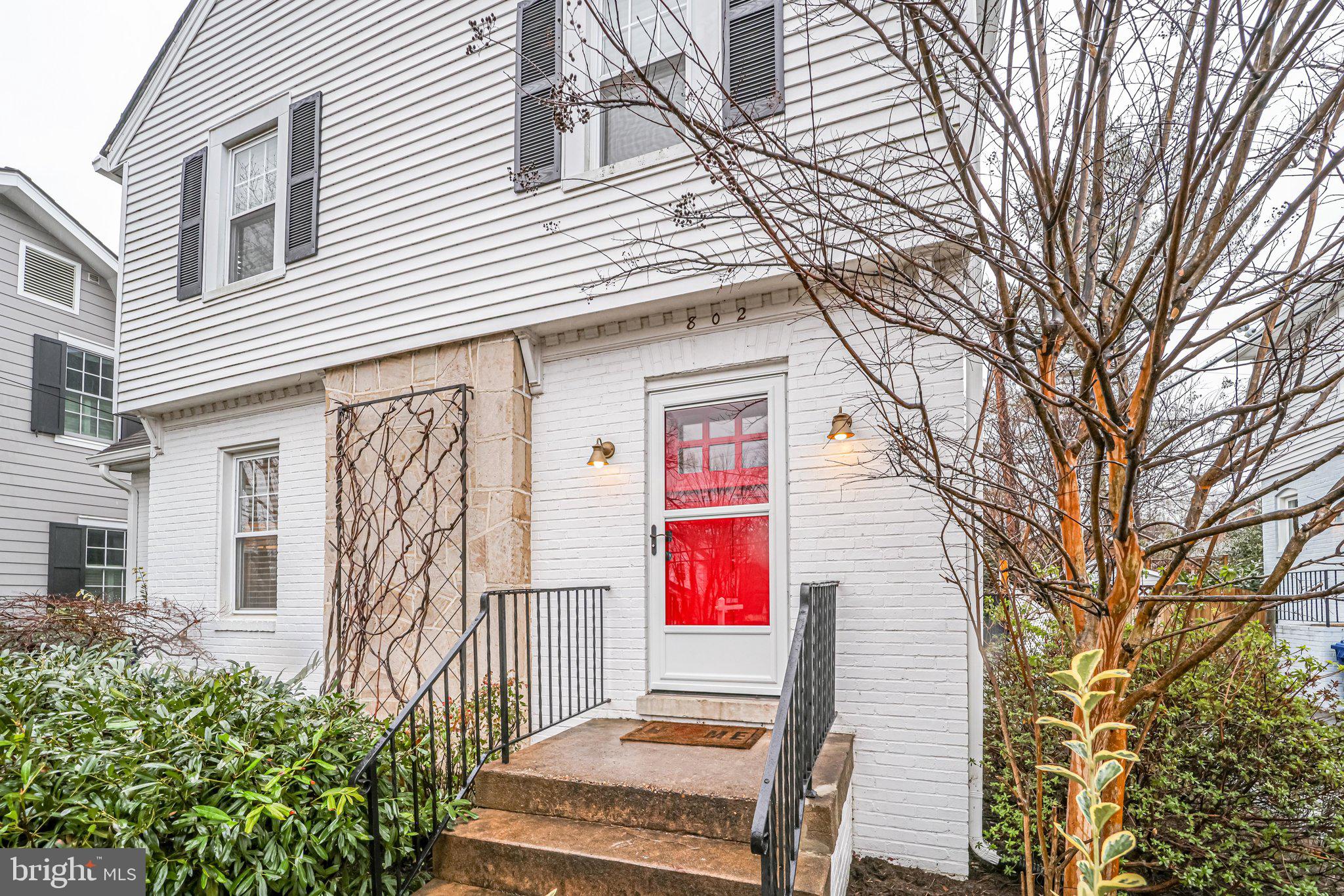 802 Russell Road Alexandria, VA 22301 - Photo 3 of 28 White exterior frames cheerful red front door