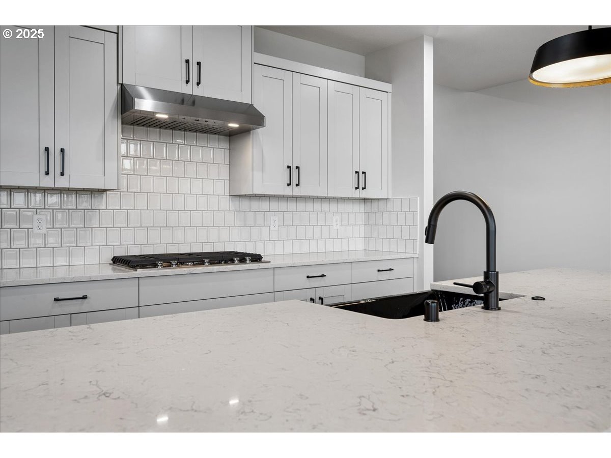 3517 North 11th Circle Ridgefield, WA 98642 - Photo 15 of 44 a kitchen with a sink a stove and cabinets