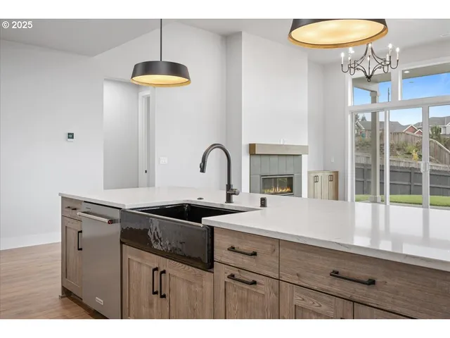 a kitchen with a sink and a chandelier