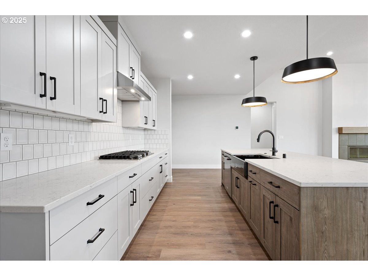 3517 North 11th Circle Ridgefield, WA 98642 - Photo 17 of 44 a large kitchen with granite countertop a sink and a stove