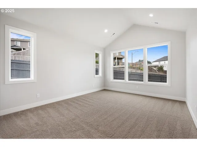 a view of a kitchen with wooden floor and windows