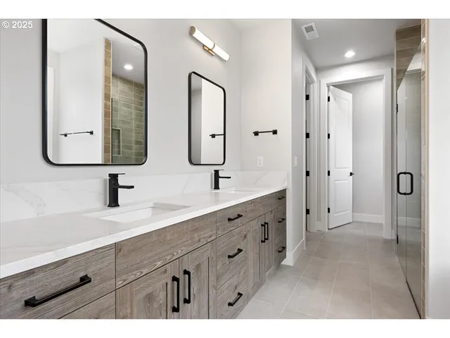 a spacious bathroom with double vanity sinks and a mirror