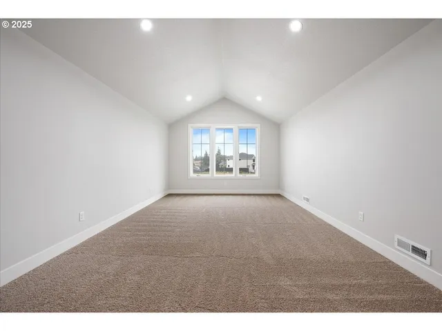 a view of an empty room and a window