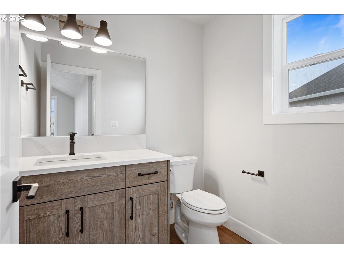 3517 North 11th Circle Ridgefield, WA 98642 - Photo 33 of 44 a bathroom with a sink vanity mirror and toilet