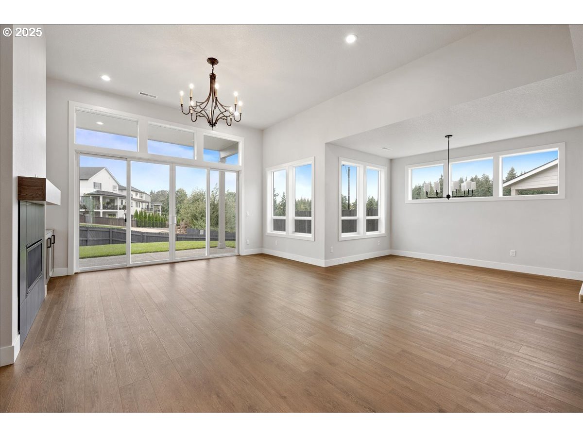 3517 North 11th Circle Ridgefield, WA 98642 - Photo 7 of 44 a view of an empty room with wooden floor and a window