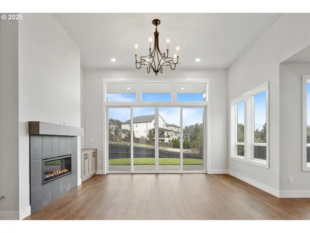 a view of an empty room with a fireplace and a window