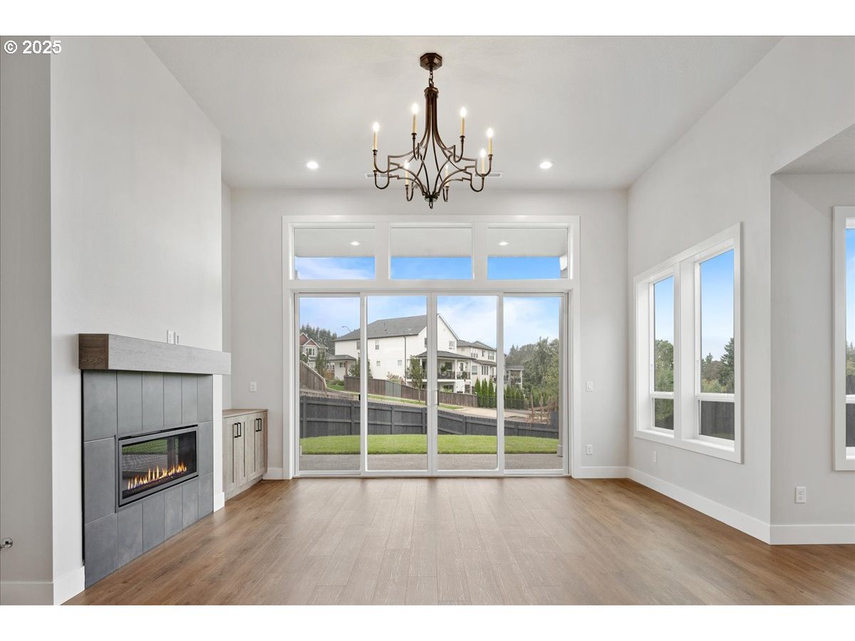 3517 North 11th Circle Ridgefield, WA 98642 - Photo 8 of 44 a view of an empty room with a fireplace and a window