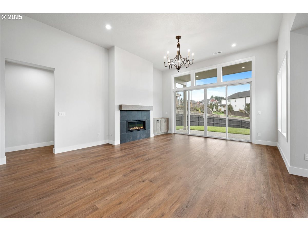 3517 North 11th Circle Ridgefield, WA 98642 - Photo 9 of 44 a view of an empty room with wooden floor and a window