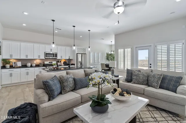 a kitchen with stainless steel appliances granite countertop a sink a stove and a wooden floor