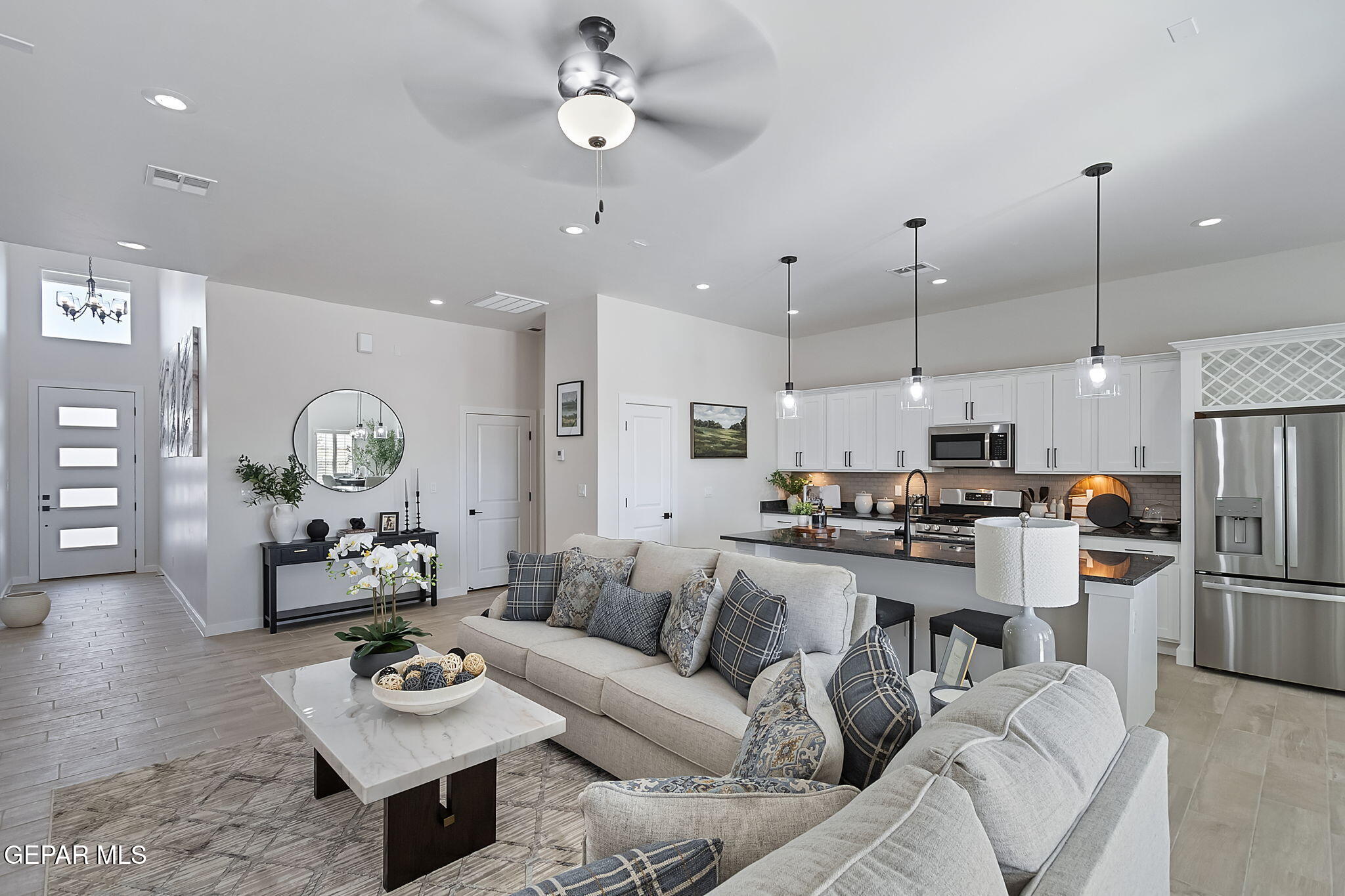 3849 Object Place El Paso, TX 79938 - Photo 10 of 18 a living room with furniture kitchen view and a chandelier