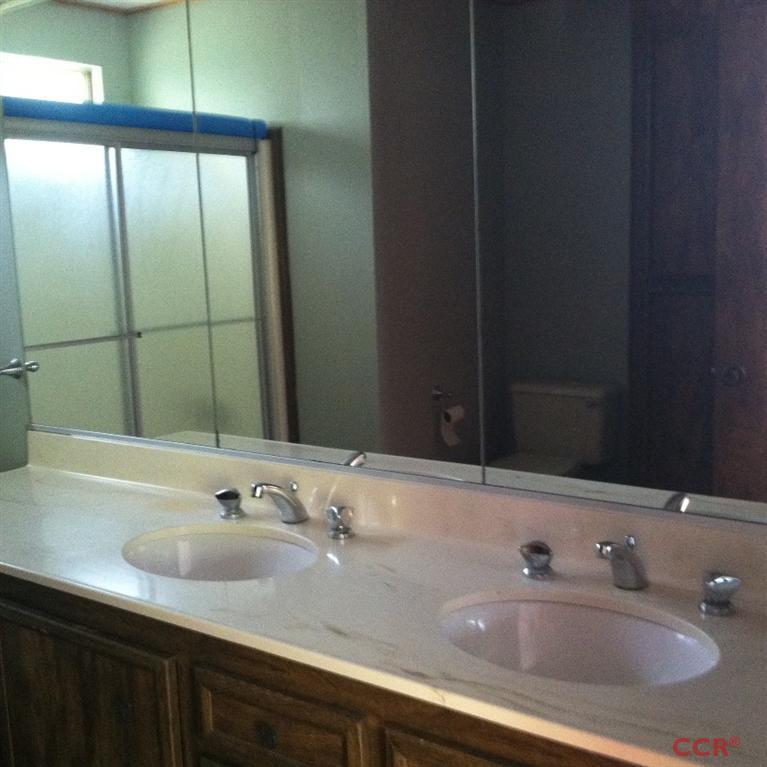 1569 Sycamore Canyon Road Santa Barbara, CA 93108 - Photo 22 of 25 a bathroom with a double vanity sink and a mirror