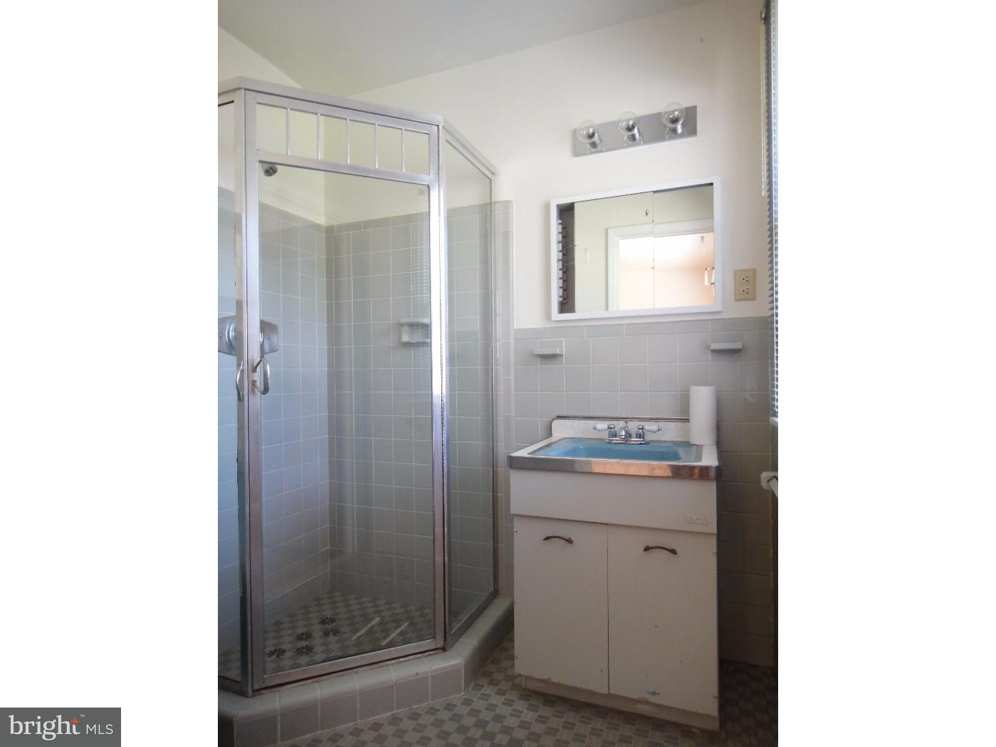 823 Suffolk Road Jenkintown, PA 19046 - Photo 12 of 19 a bathroom with a granite countertop sink a shower and a mirror