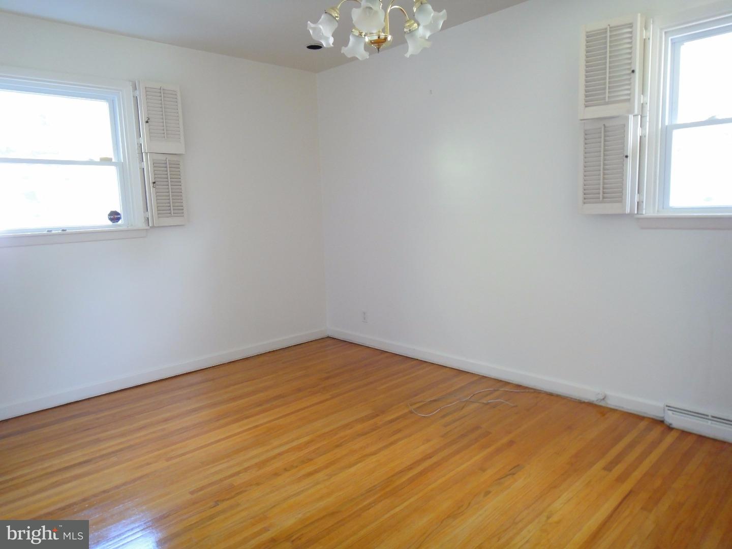 823 Suffolk Road Jenkintown, PA 19046 - Photo 15 of 19 an empty room with wooden floor and windows