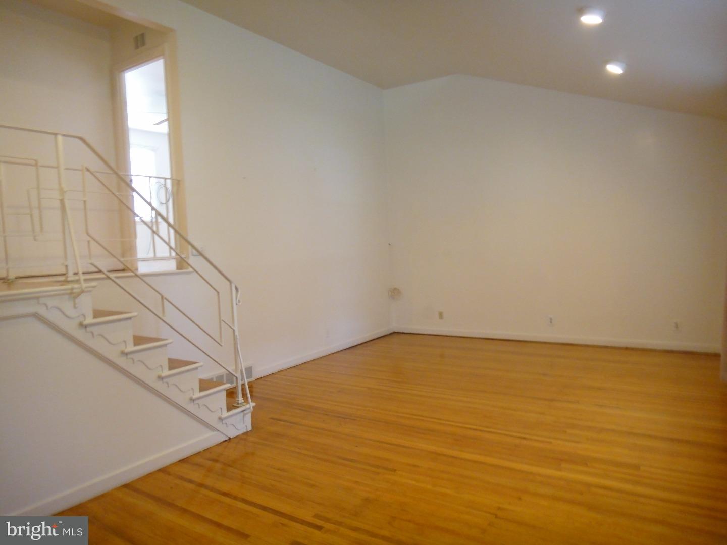 823 Suffolk Road Jenkintown, PA 19046 - Photo 4 of 19 a view of an empty room with wooden floor and a window