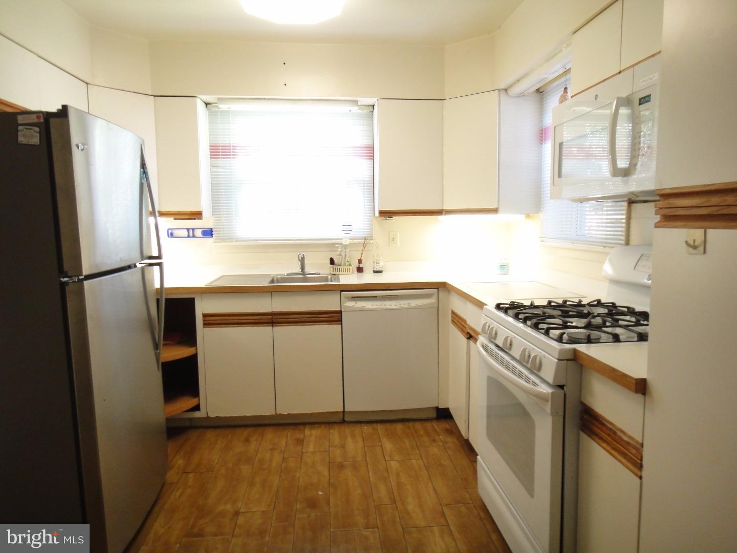 823 Suffolk Road Jenkintown, PA 19046 - Photo 7 of 19 a kitchen with a sink stove and refrigerator