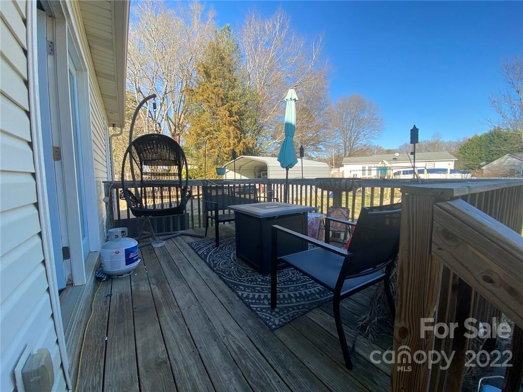 104 Dameron Road Bessemer City, NC 28016 - Photo 12 of 15 a view of a balcony with chairs and wooden floor