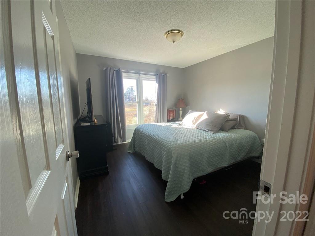 104 Dameron Road Bessemer City, NC 28016 - Photo 14 of 15 a bedroom with a bed and wooden floor