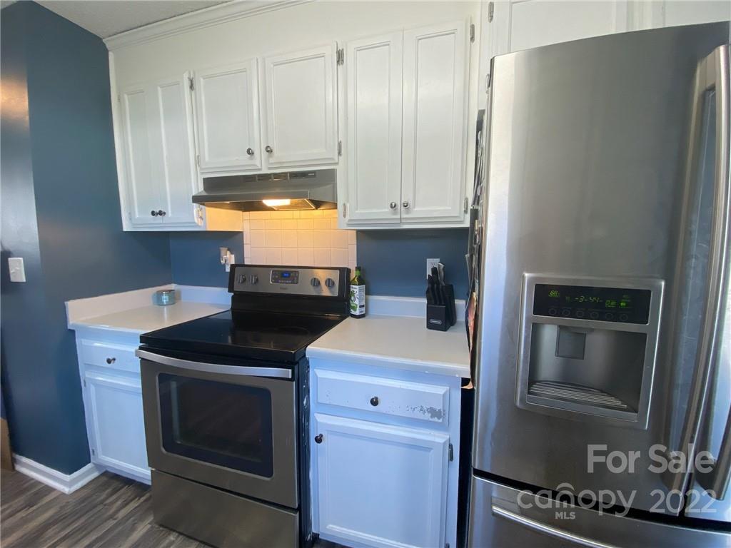 104 Dameron Road Bessemer City, NC 28016 - Photo 7 of 15 a kitchen with granite countertop a stove and a refrigerator with cabinets