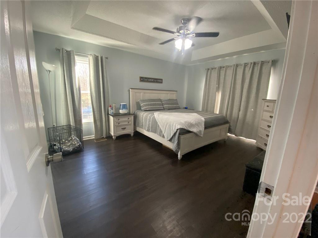 104 Dameron Road Bessemer City, NC 28016 - Photo 10 of 15 a spacious bedroom with a bed and a chandelier