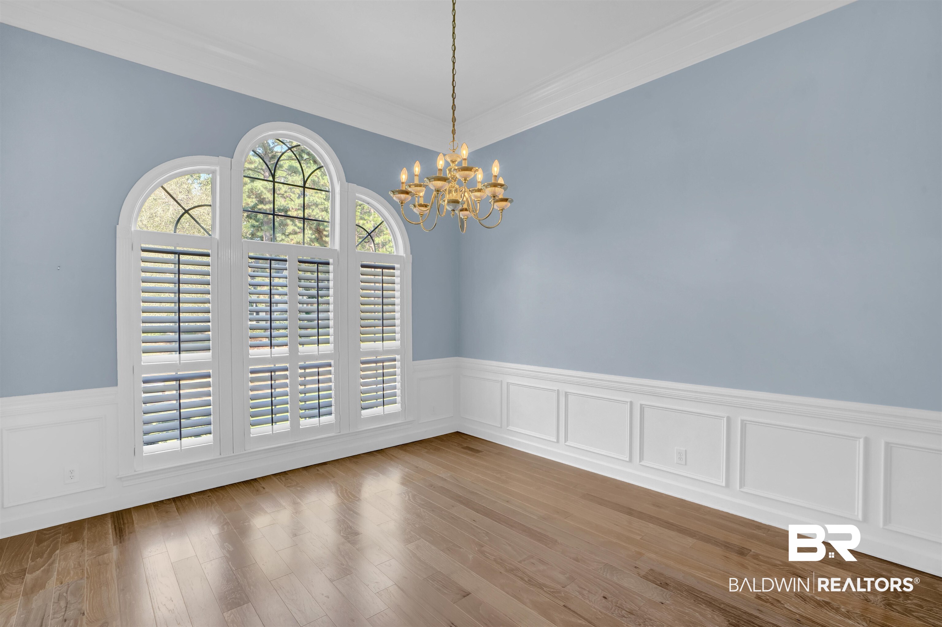 111 Beaver Dam Road Fairhope, AL 36532 - Photo 6 of 51 Unfurnished dining area featuring a notable chandelier, hardwood / wood-style floors, and crown molding