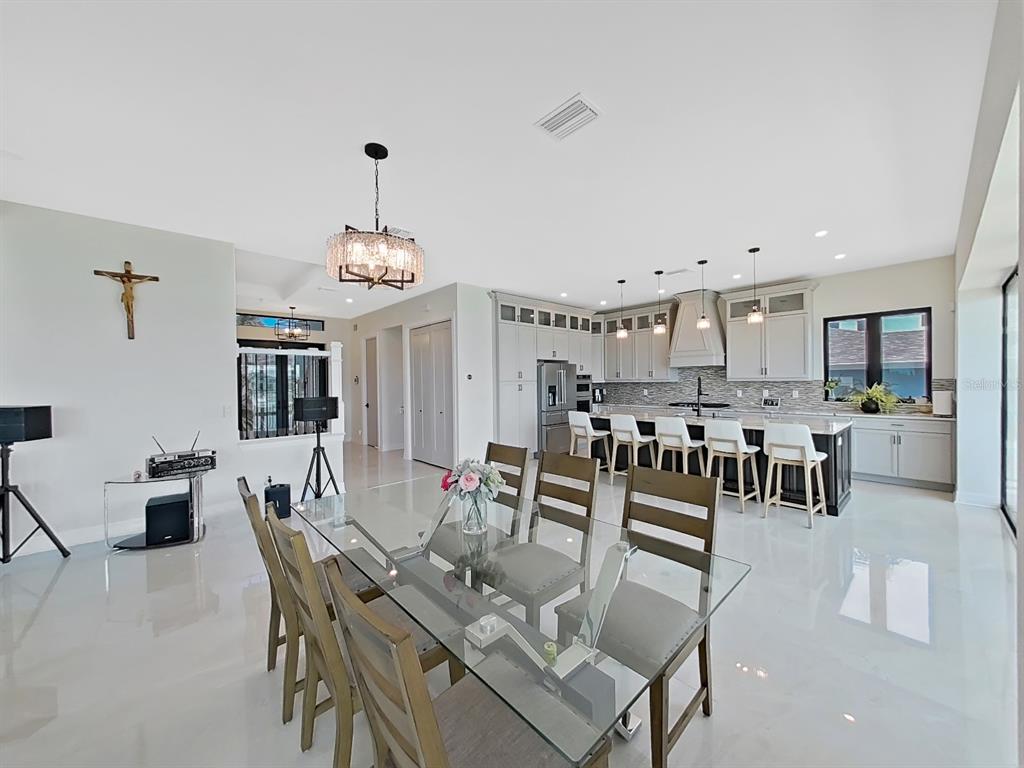 882 Bay Point Drive Madeira Beach, FL 33708 - Photo 11 of 73 a view of a dining room with furniture and chandelier