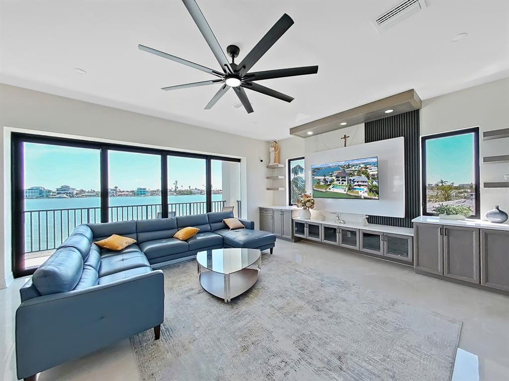 882 Bay Point Drive Madeira Beach, FL 33708 - Photo 13 of 73 a living room with furniture and a large window