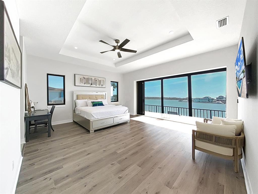 882 Bay Point Drive Madeira Beach, FL 33708 - Photo 25 of 73 a bedroom with a bed and a large window
