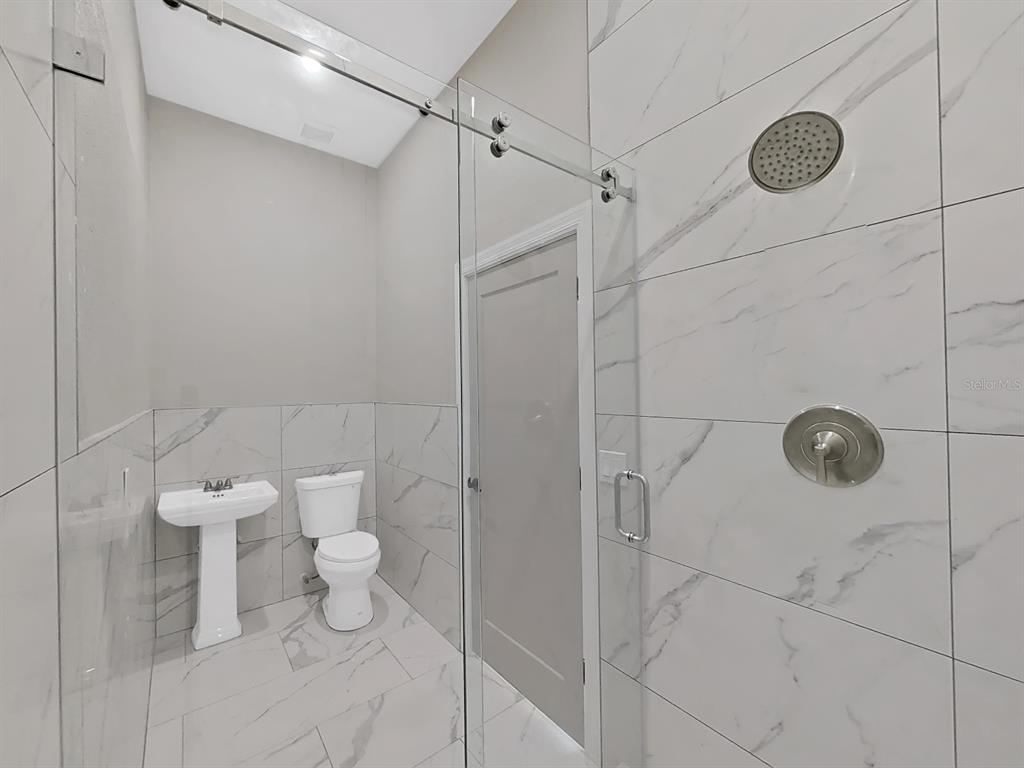 882 Bay Point Drive Madeira Beach, FL 33708 - Photo 47 of 73 a bathroom with a toilet and a shower