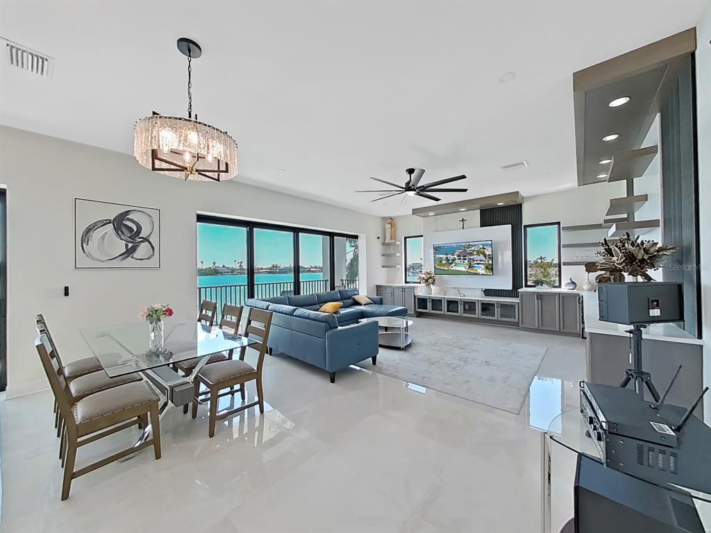 882 Bay Point Drive Madeira Beach, FL 33708 - Photo 8 of 73 a living room with furniture chandelier and a large window