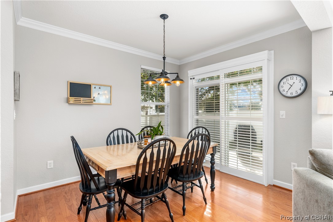 2124 Piedmont Road Suffolk, VA 23435 - Photo 18 of 41 Dining room featuring crown molding, light hardwood / wood-style flooring, and an inviting chandelier