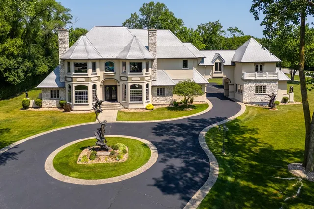 a front view of a house with swimming pool having outdoor seating