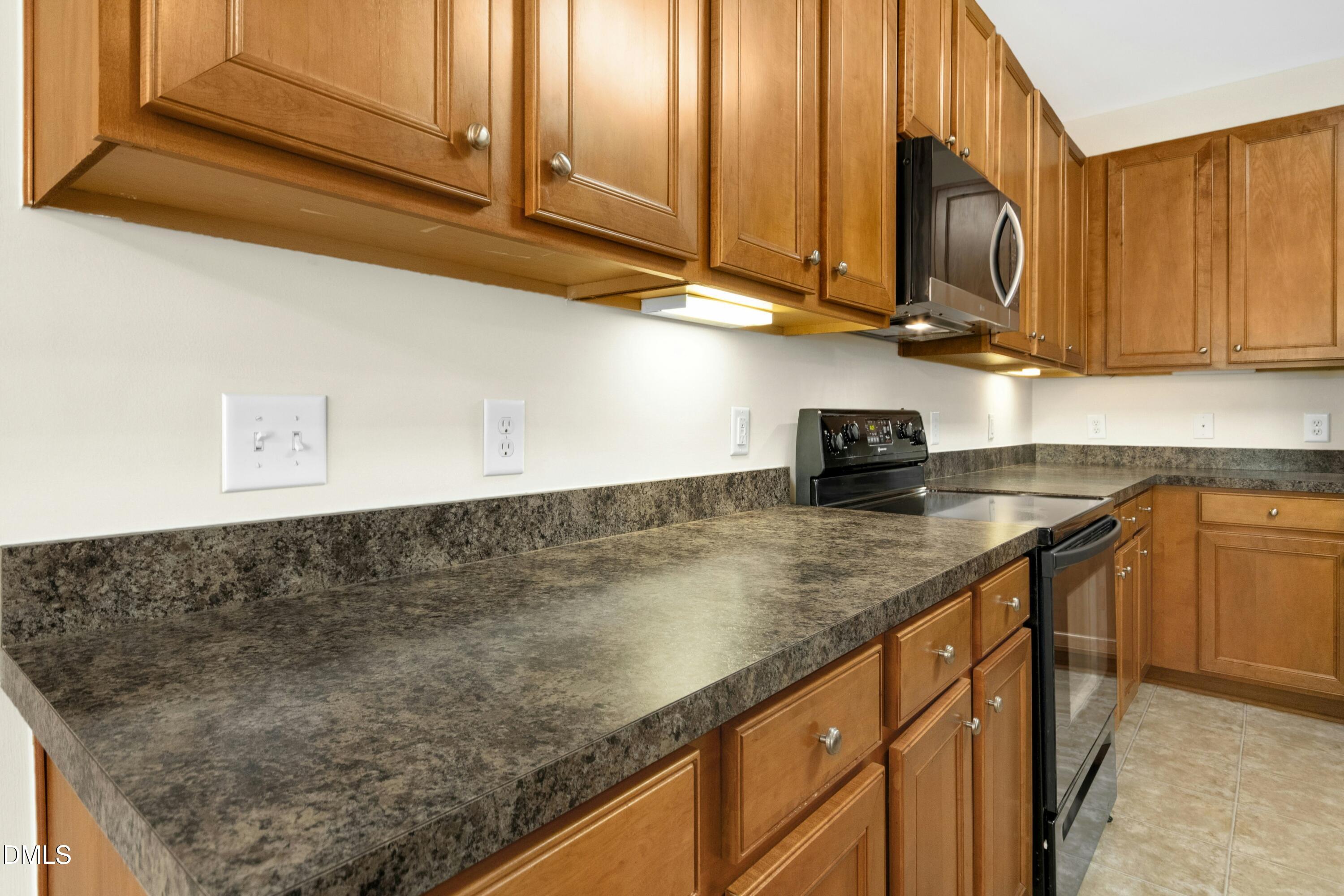 5541 Nur Lane Raleigh, NC 27606 - Photo 13 of 33 a kitchen with stainless steel appliances granite countertop a sink a stove and cabinets