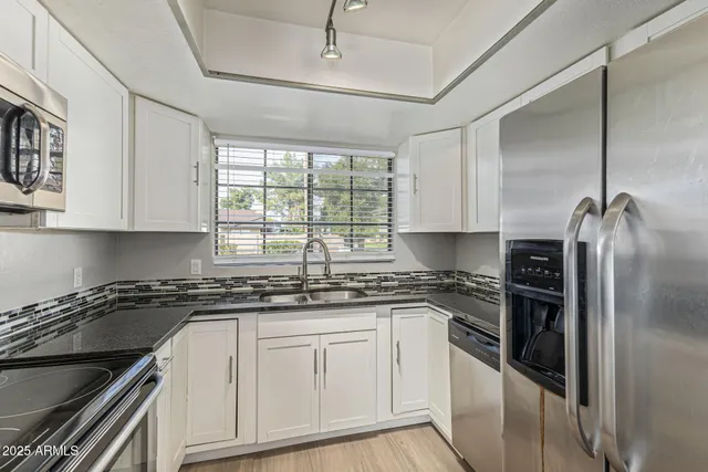 a kitchen with a sink stove and refrigerator