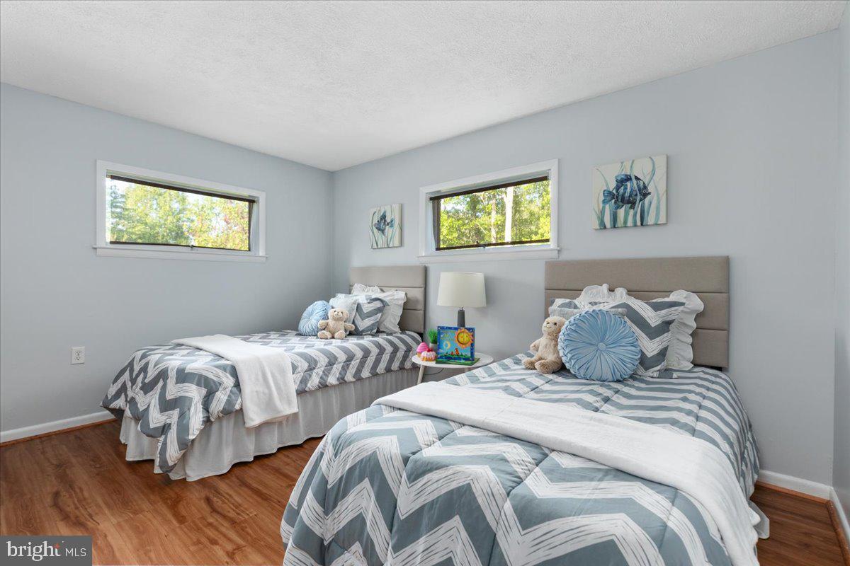 146 Lizzie Mills Road Castleton, VA 22716 - Photo 32 of 91 a bedroom with two beds and a painting on the wall