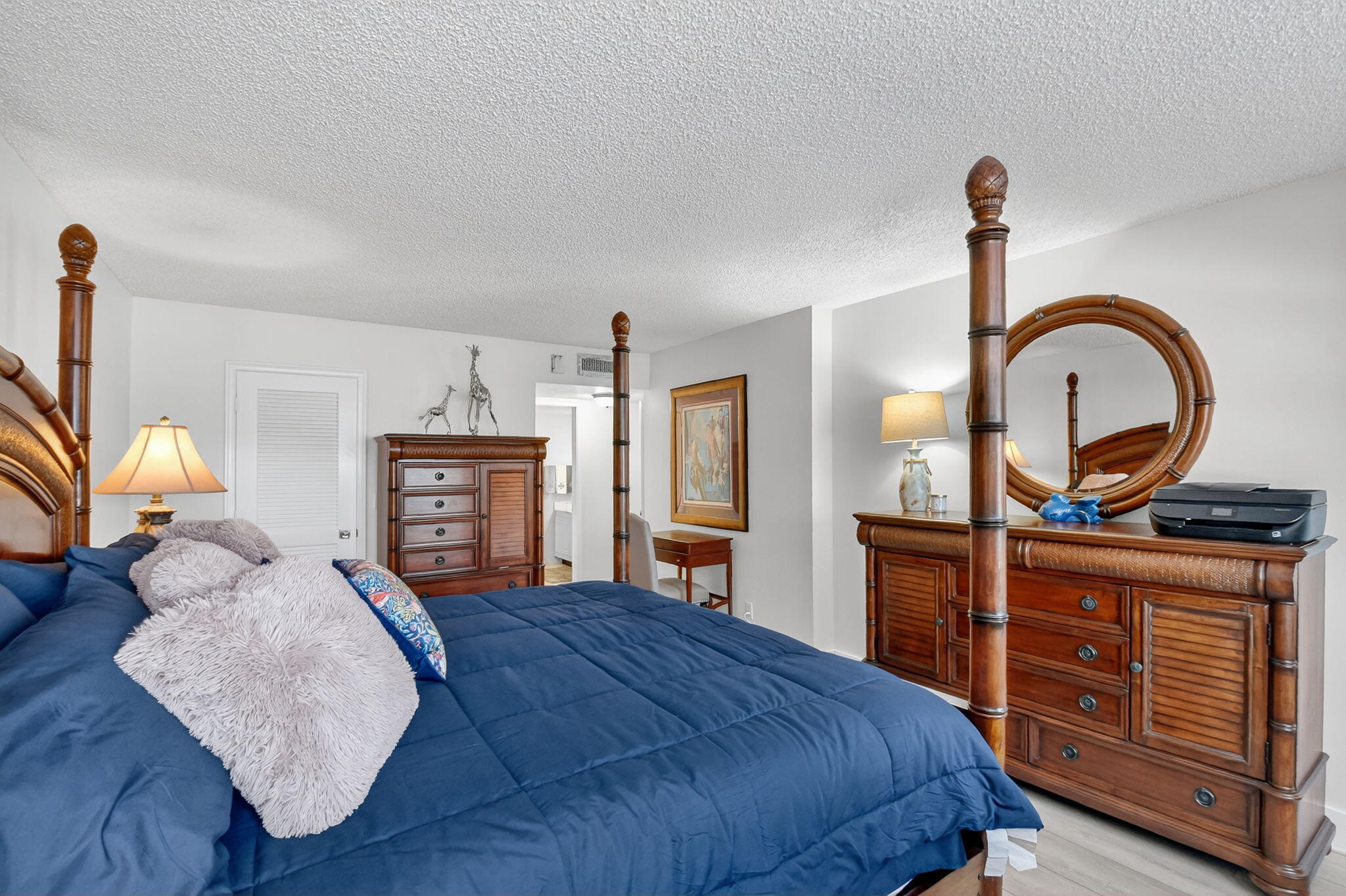 3400 North Ocean Drive, Unit 405 Riviera Beach, FL 33404 - Photo 19 of 58 a bedroom with a bed and dresser with mirror