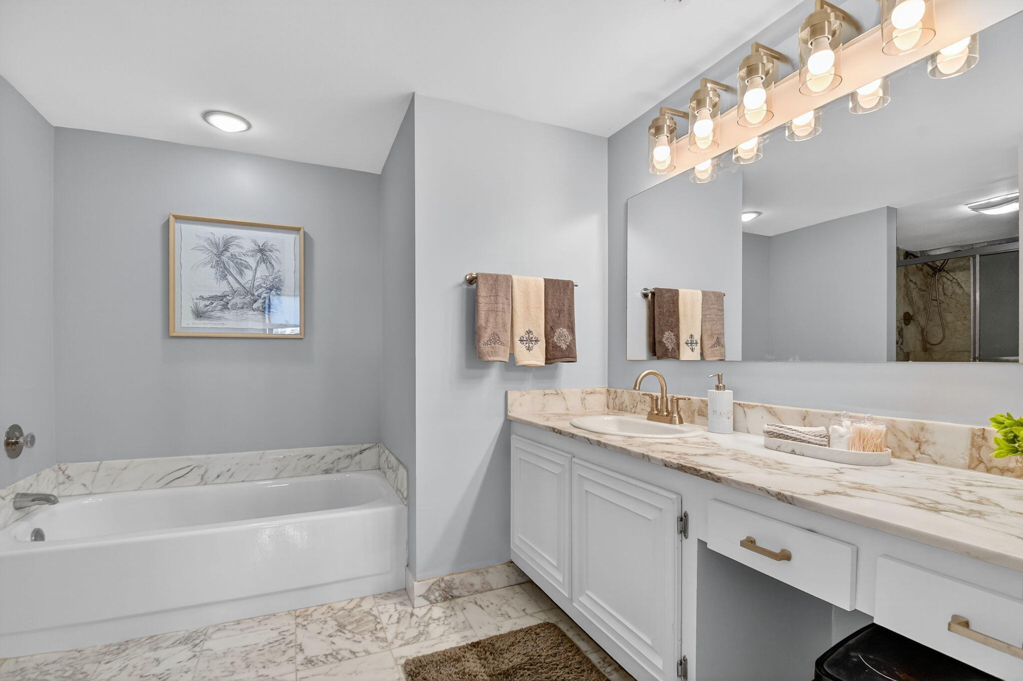 3400 North Ocean Drive, Unit 405 Riviera Beach, FL 33404 - Photo 21 of 58 a bathroom with a tub a double vanity sink and mirror