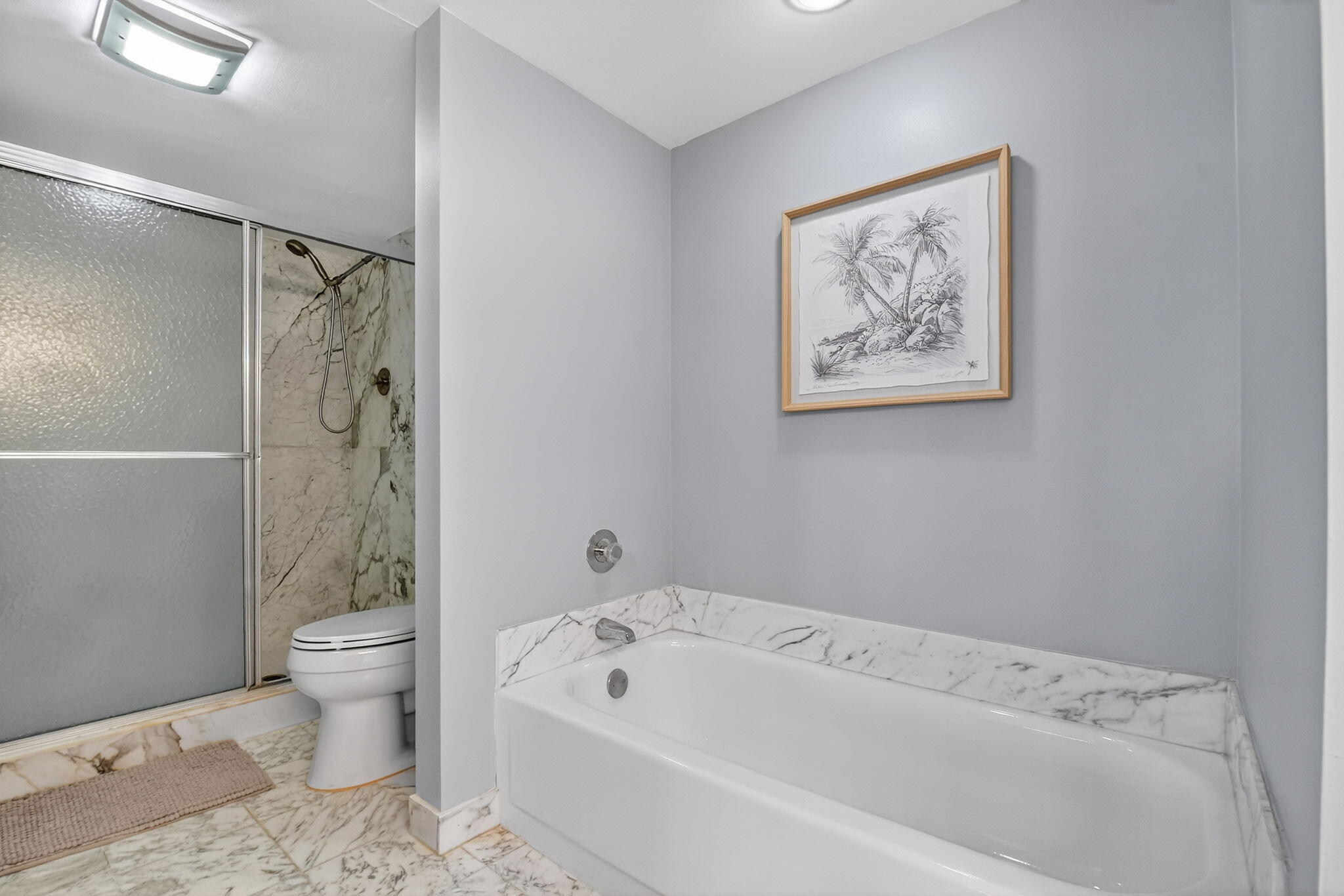 3400 North Ocean Drive, Unit 405 Riviera Beach, FL 33404 - Photo 22 of 58 a bathroom with a bathtub shower and toilet