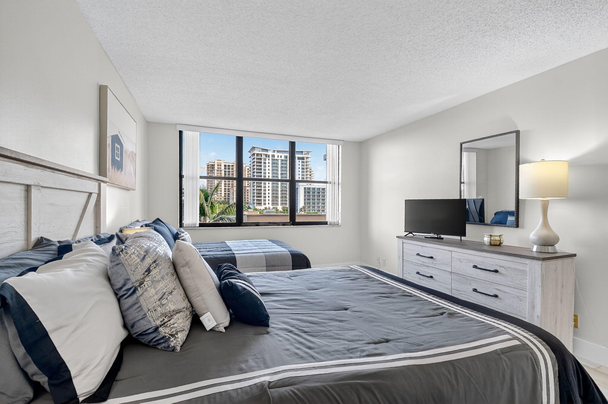 3400 North Ocean Drive, Unit 405 Riviera Beach, FL 33404 - Photo 23 of 58 a bedroom with a bed and a flat screen tv