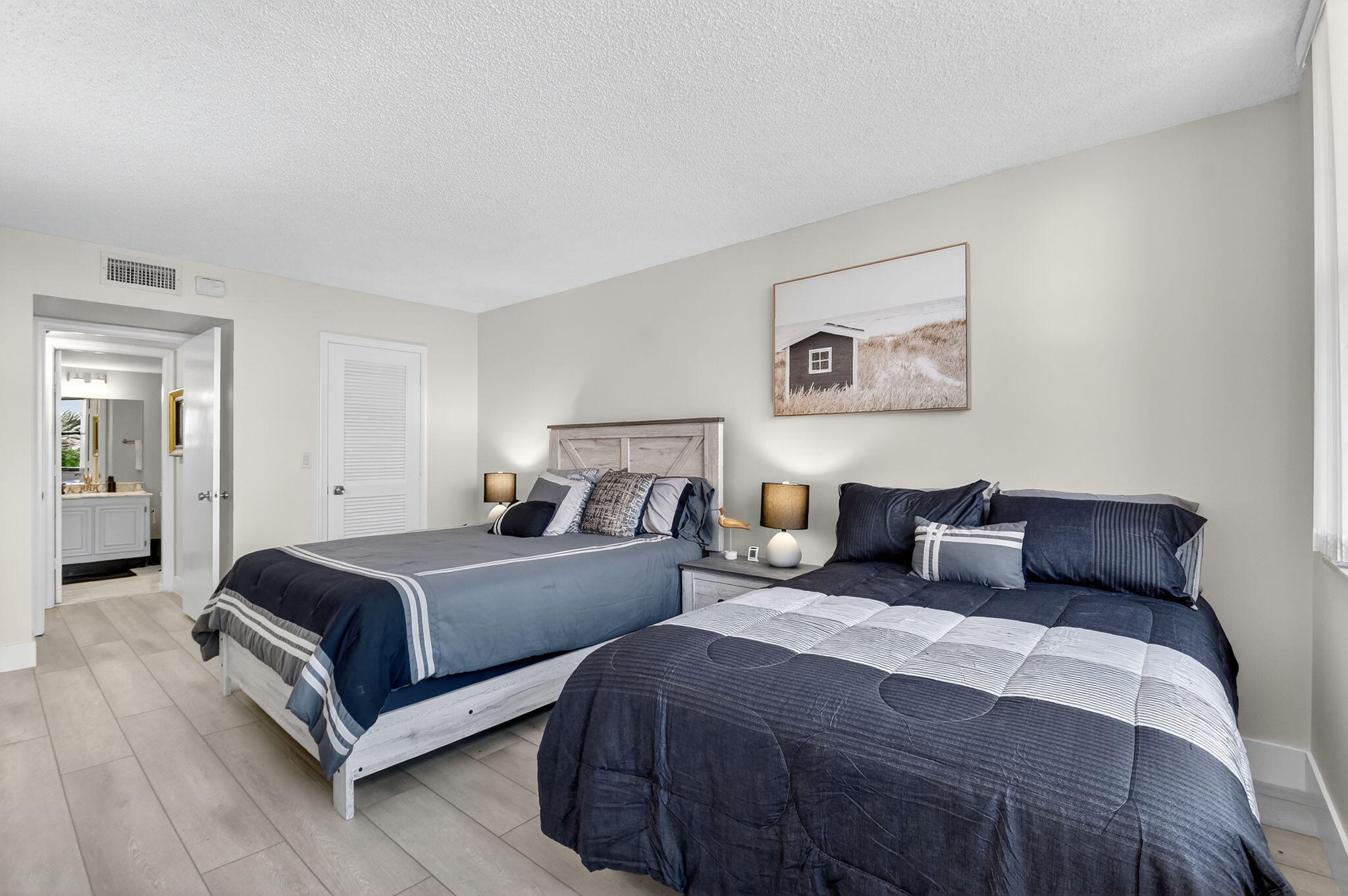 3400 North Ocean Drive, Unit 405 Riviera Beach, FL 33404 - Photo 25 of 58 a bedroom with two beds and painting on the wall