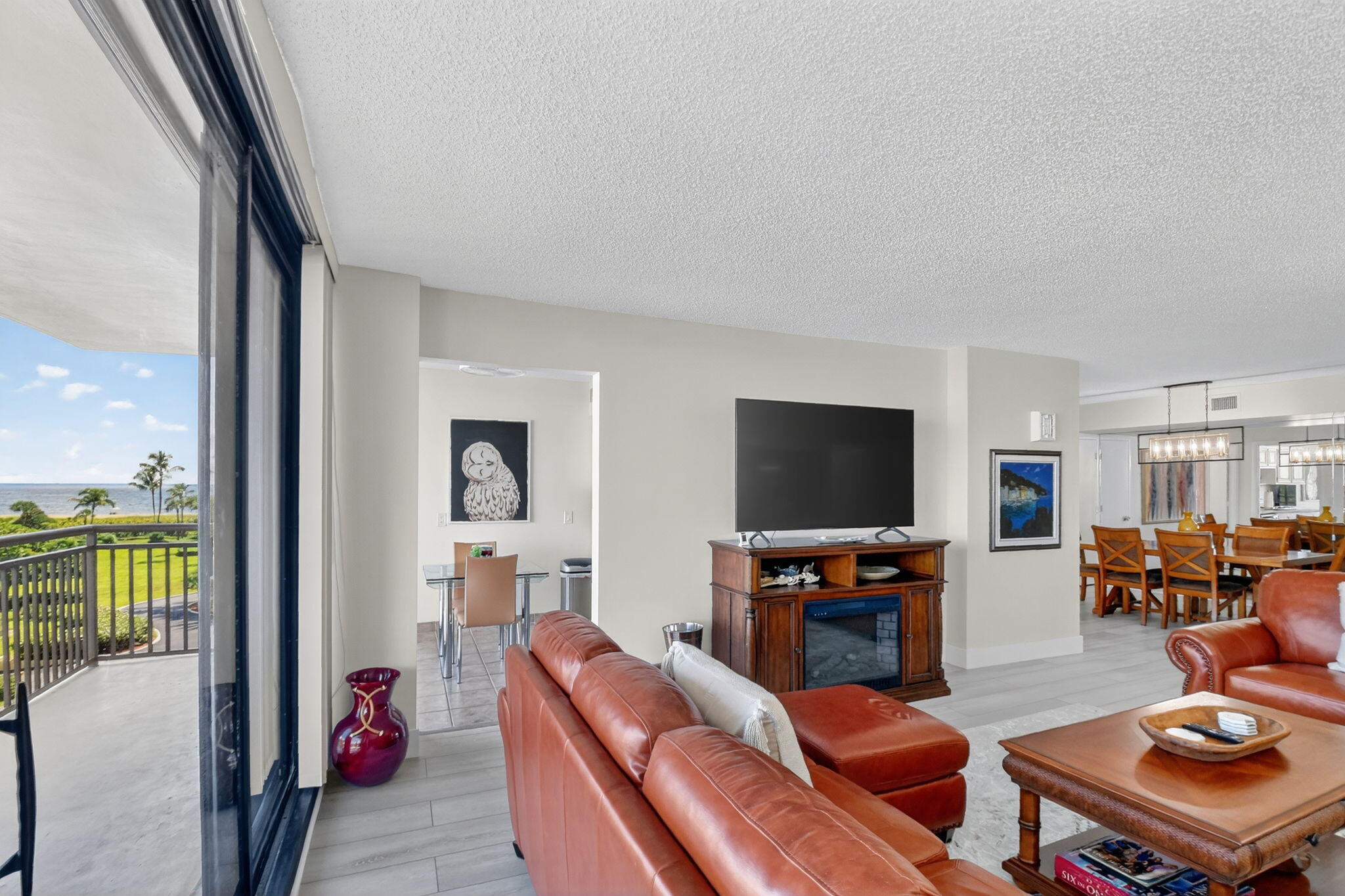 3400 North Ocean Drive, Unit 405 Riviera Beach, FL 33404 - Photo 6 of 58 a living room with furniture and a flat screen tv with wooden floor