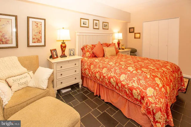 a bed sitting in a bedroom next to a window