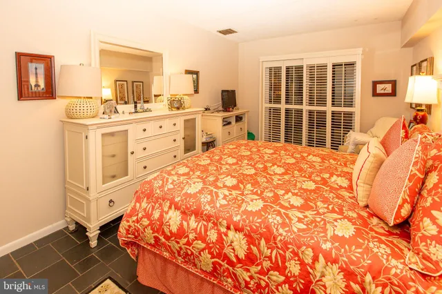 a living room with furniture rug and lamp