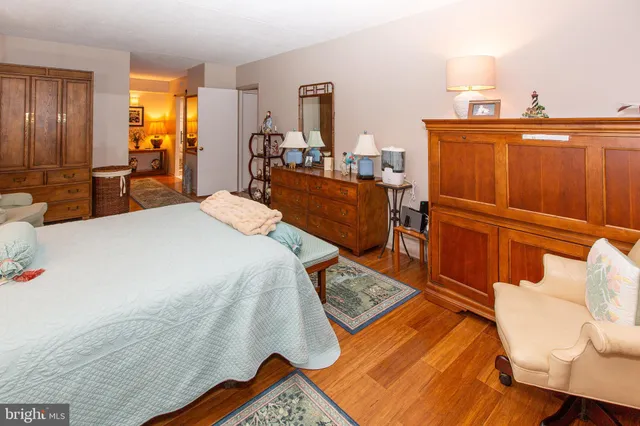 a bedroom with bed and wooden floor