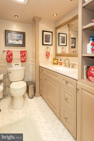 a bathroom with a toilet sink vanity and shower