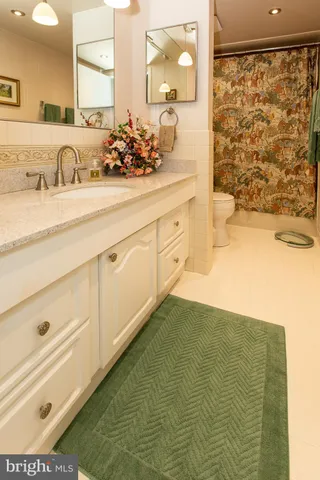 a bathroom with a sink a mirror and a shower