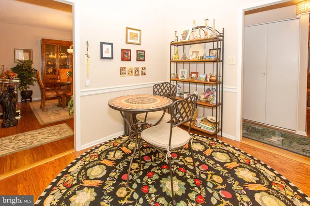 a kitchen with a refrigerator and white cabinets