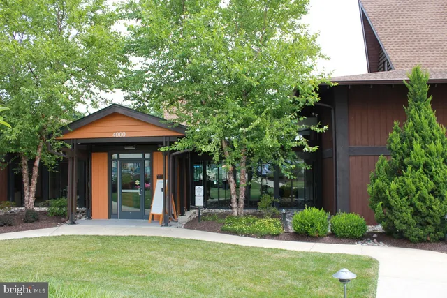 a view of a house with backyard sitting area and a garden